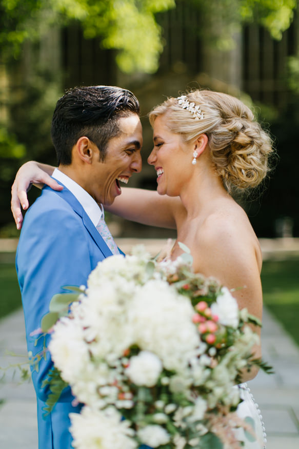 Bride and groom laugh together on their wedding day in Ann Arbor