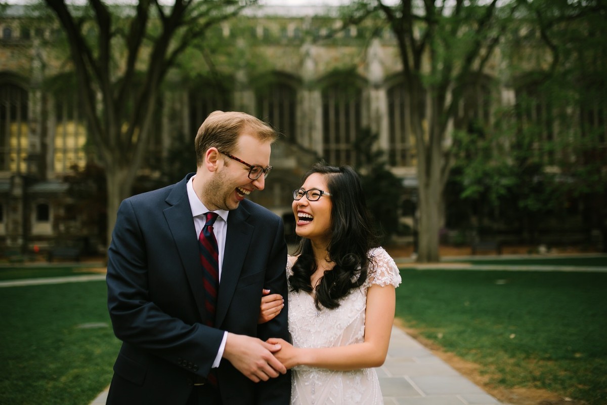 Bride and groom smile with excitement in a portrait on their wedding day in Ann Arbor, Michigan.